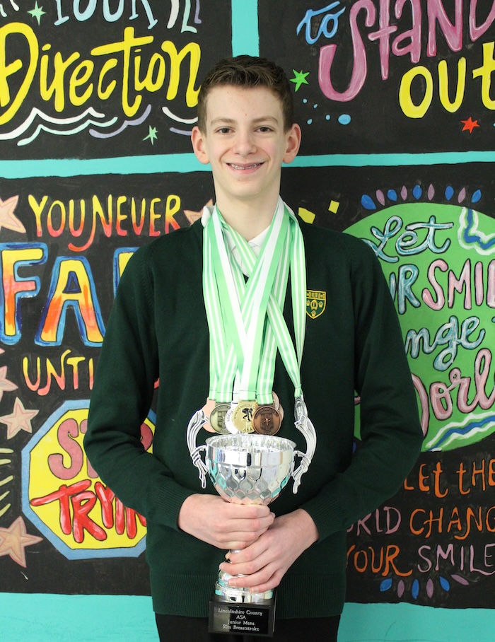 Oliver Clarke with medals and trophy